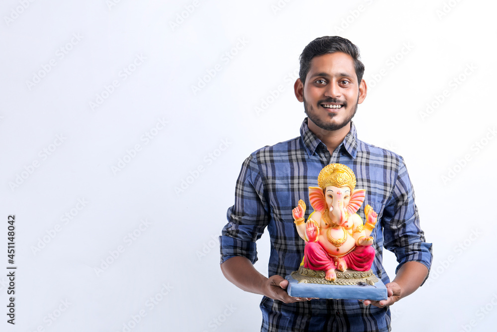 Celebrate ganesha festival.young indian handsome man with lord ganesha. Celebrate ganesha festival.young indian handsome man with lord ganesha.