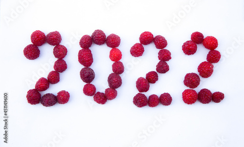 2022 made from fresh raspberries on white background, Happy New Year decoration. Summer 2022, happy gardening