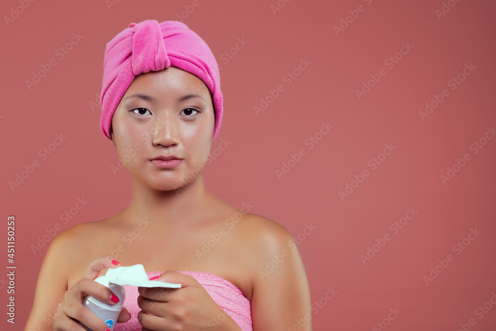 Young chinese woman skin care isolated from the background, beauty concept