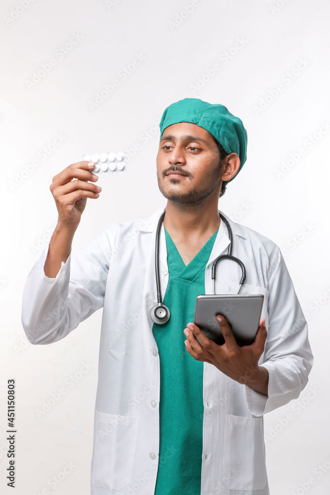 Young indian doctor checking medicine at clinic Young indian doctor checking medicine at clinic
