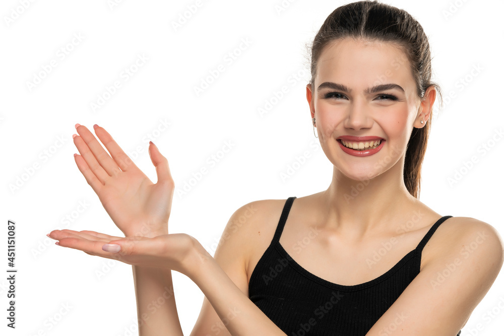 A young beautiful smiling woman with tied hair advertises an imaginary produc A young beautiful smiling woman with tied hair advertises an imaginary produc