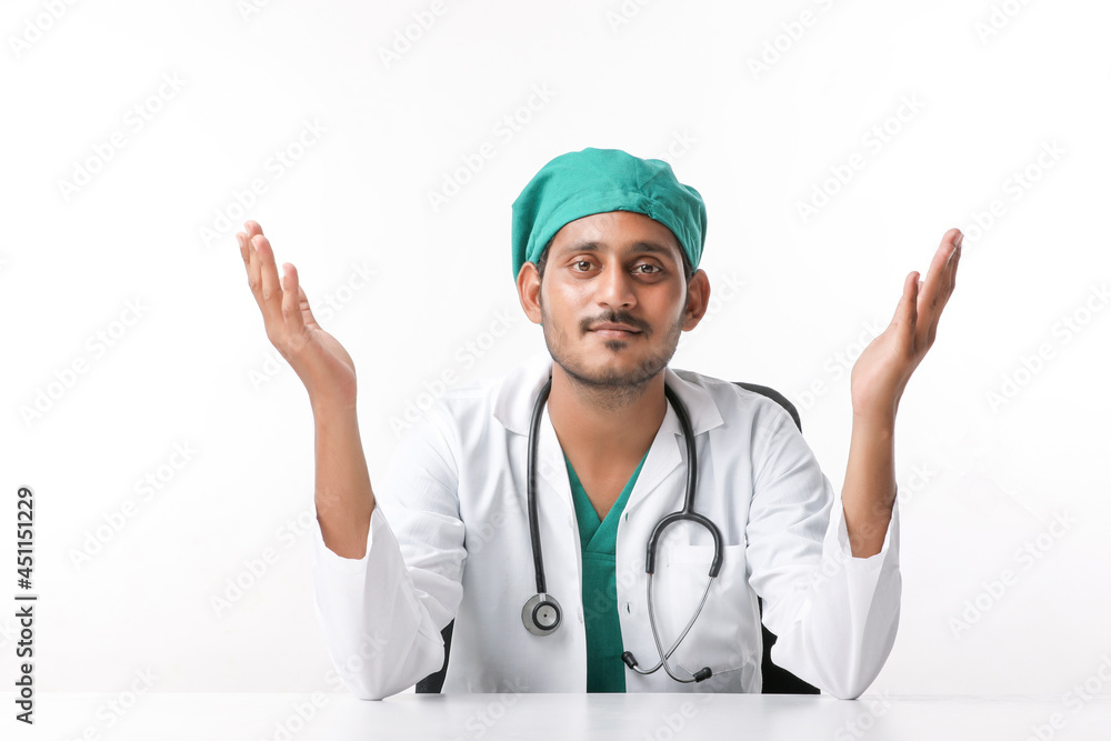 Young indian male doctor showing expression at clinic.