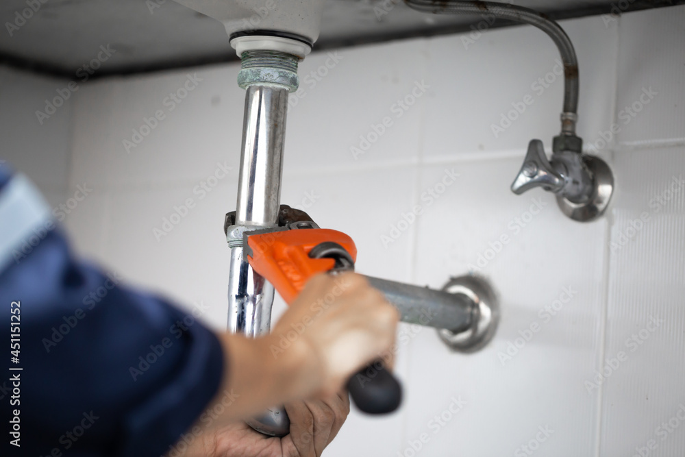 plumber at work in a bathroom, plumbing repair service, assemble and install concept. plumber at work in a bathroom, plumbing repair service, assemble and install concept.