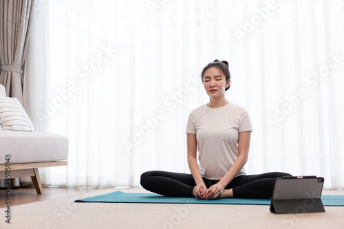Productive activity concept a calm girl concentrating on meditating alone among peaceful atmosphere in the living room