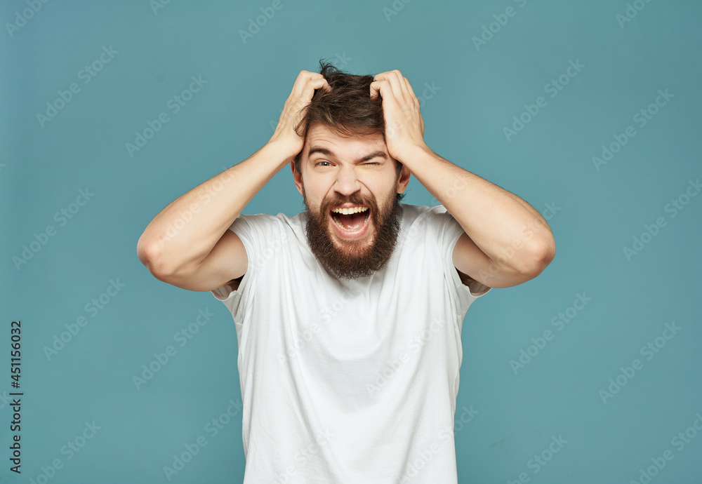 emotional man in a white t-shirt hand gestures anger blue background emotional man in a white t-shirt hand gestures anger blue background
