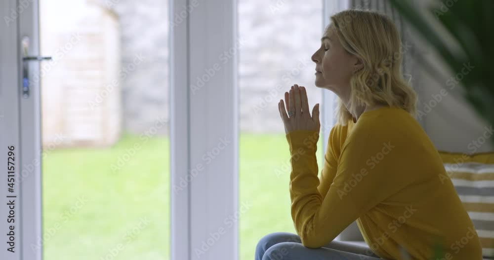 Sad woman sitting on couch struggling with depression Sad woman sitting on couch struggling with depression