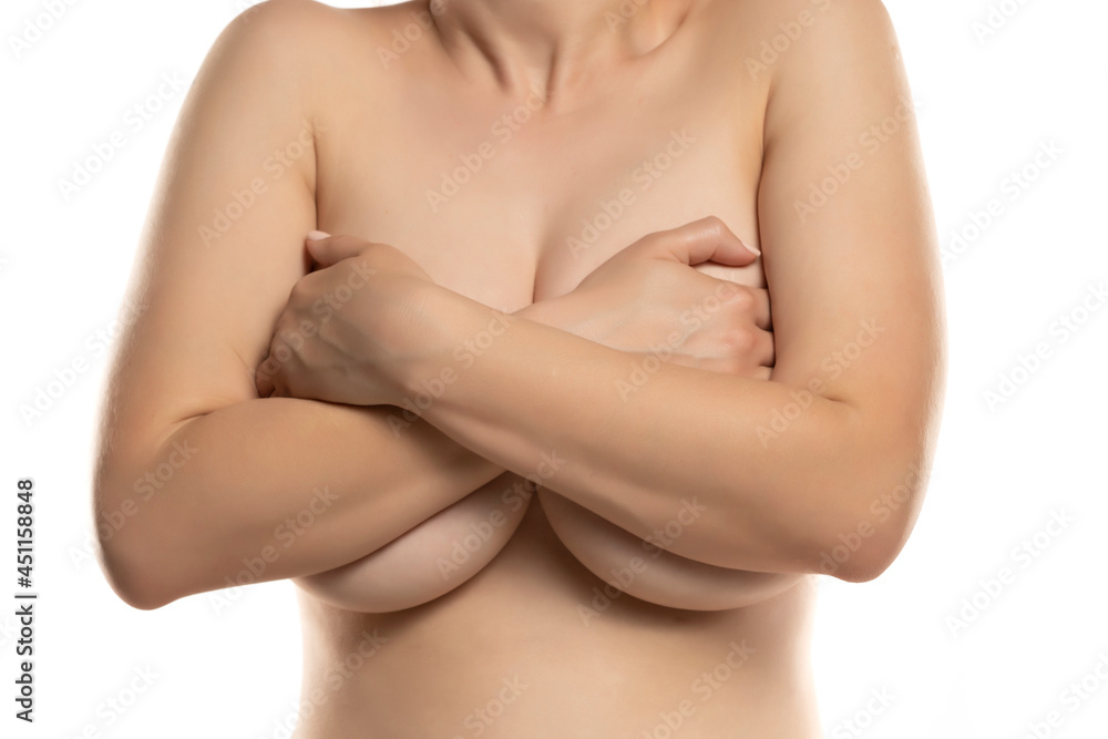 the woman covers with both hands her large breasts the woman covers with both hands her large breasts