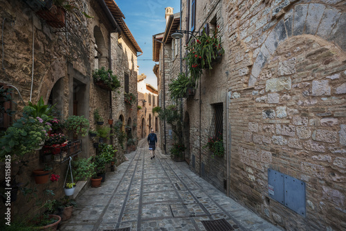 A young man walk along the beautiful streets of Spello  Umbria
