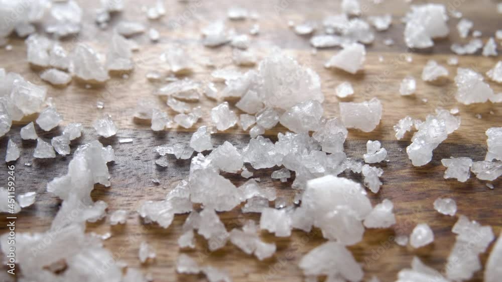 Rough sea salt on a wooden rustic surface. Macro. Dolly Shot Rough sea salt on a wooden rustic surface. Macro. Dolly Shot