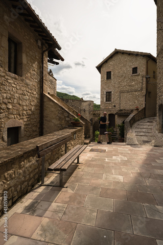 a young man walking into the little street of Vallo di nera  Umbria