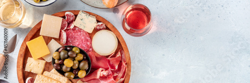 Foto Charcuterie and cheese platter with wine panorama, shot from the top with a place for text
