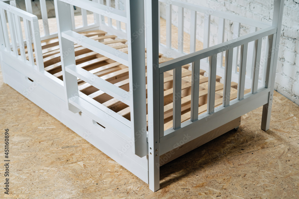 The image of the child's bed, in the frame of the bed legs and drawers. The image of the child's bed, in the frame of the bed legs and drawers.