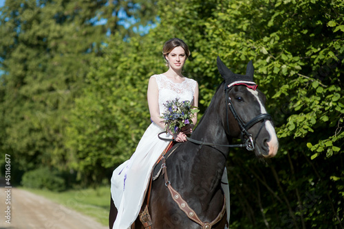 Beautiful portrait of woman bride with horse