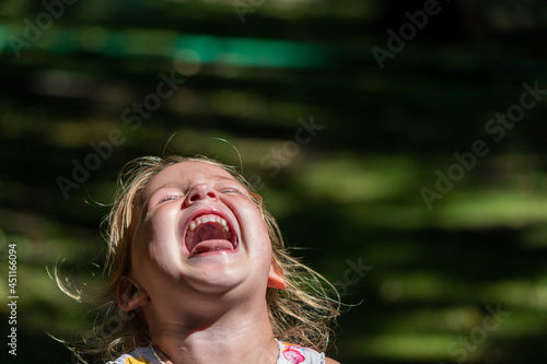 the child is crying and laughing, the child is hysterical