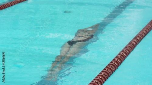 Swimming. Girl slowly slides underwater in the pool. Water sports.