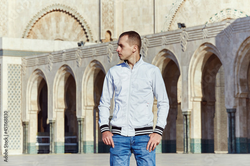 Portrait of a man on the background of the Hassan II Mosque in Morocco, Casablanca