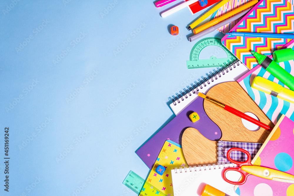Stationery accessory on blue background. Education and freelance work concept