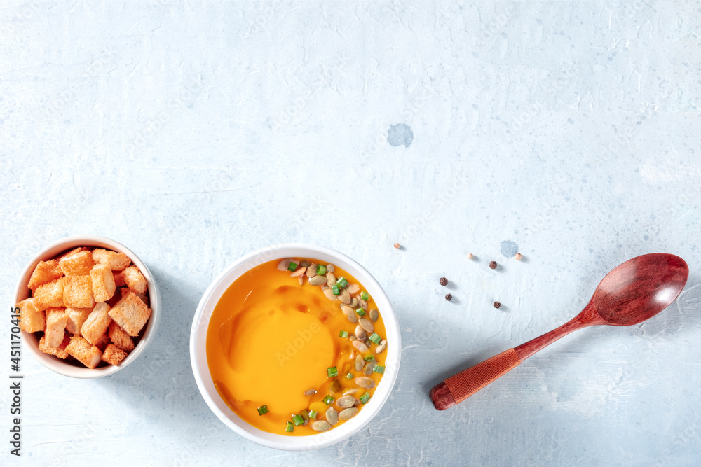Spicy pumpkin soup with croutons, shot from above with copy space. Butternot squash cream Spicy pumpkin soup with croutons, shot from above with copy space. Butternot squash cream