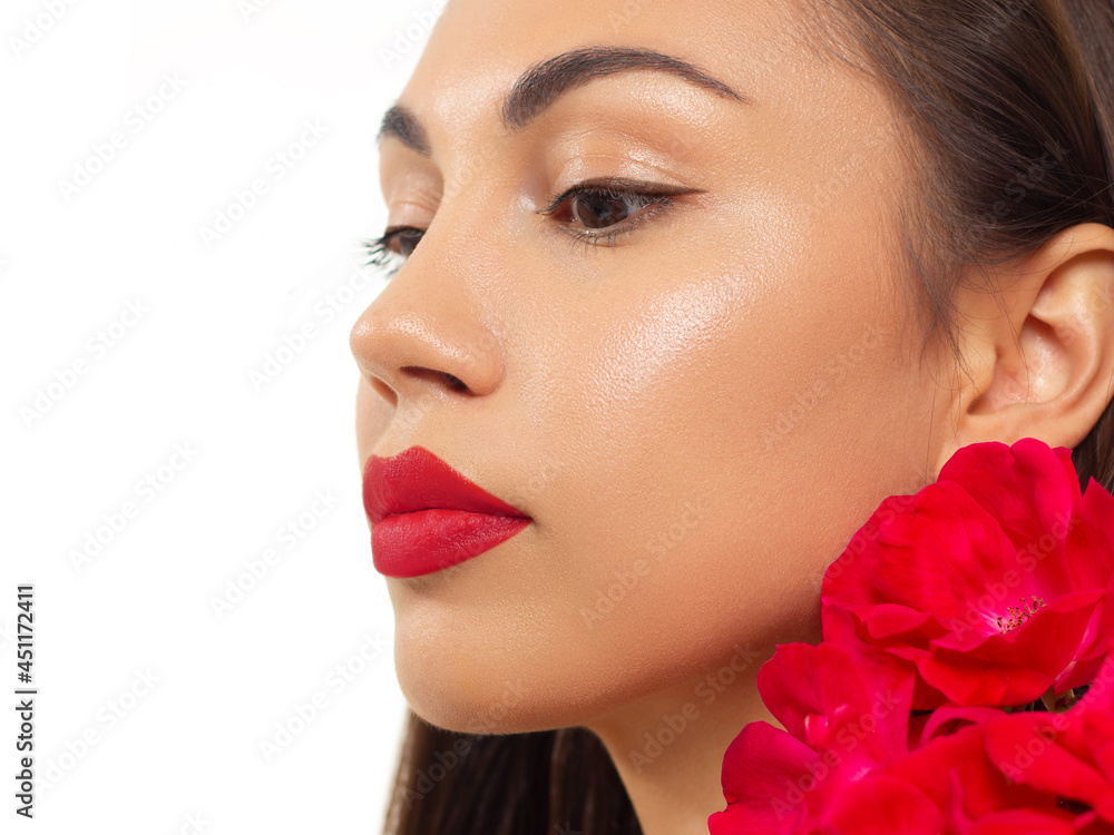 Fototapeta premium Beautiful woman with bright make up eye with sexy pink liner makeup. Fashion arrow shape on woman's eyelid. Natural lips. Chic evening make-up. Luxurious long wave hair. Shining face skin with flowers