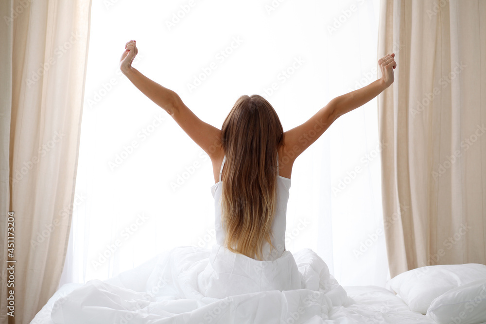 custom made wallpaper toronto digitalWoman stretching in bed after wake up, back view, entering a day happy and relaxed after good night sleep. Sweet dreams, good morning, new day, weekend, holidays concept