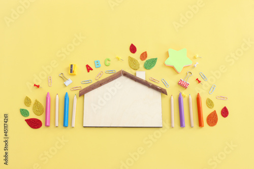 Back to school concept. Top view image of student stationery over pastel yellow background photo