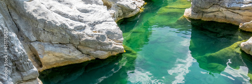 Quiet turquoise river stream along the tectonic rocks