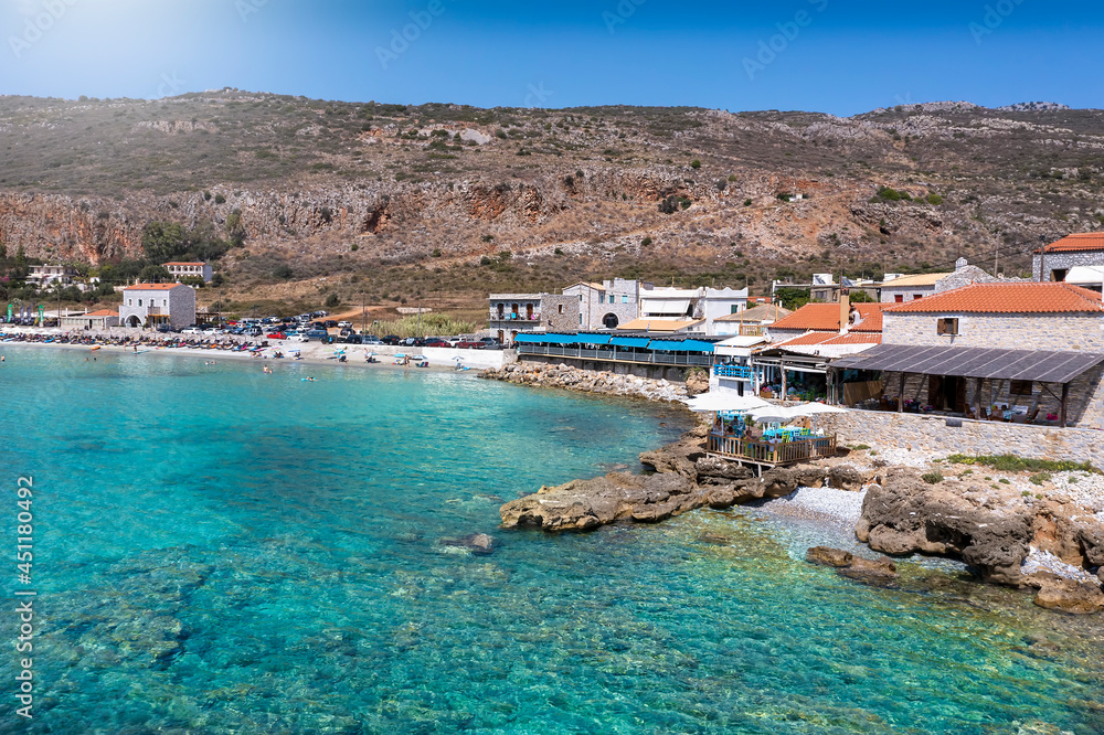 The little village and beach of Oitilo, south Mani, Peloponnese, Greece, with traditional fish taverns directly at the turquoise sea