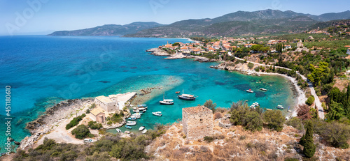 Panormiac aerial view of the marina and village of Kardamili, Mani, Peloponnese, Greece, with a traditional stone tower in front photo