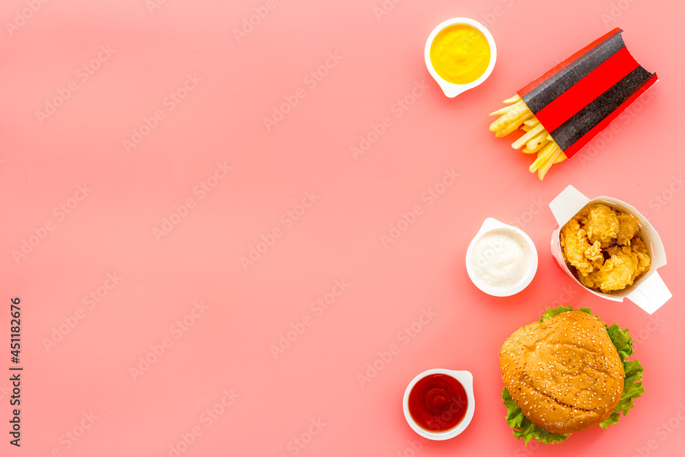 Top view of burger potatoes and chicken nuggets with sauces Top view of burger potatoes and chicken nuggets with sauces