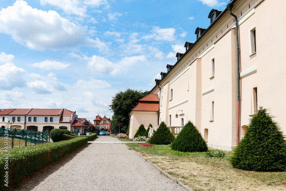 NIEPOLOMICE, POLAND - JULY 12, 2019: The royal castle and beautiful gardens in Niepolomice, Poland. NIEPOLOMICE, POLAND - JULY 12, 2019: The royal castle and beautiful gardens in Niepolomice, Poland.