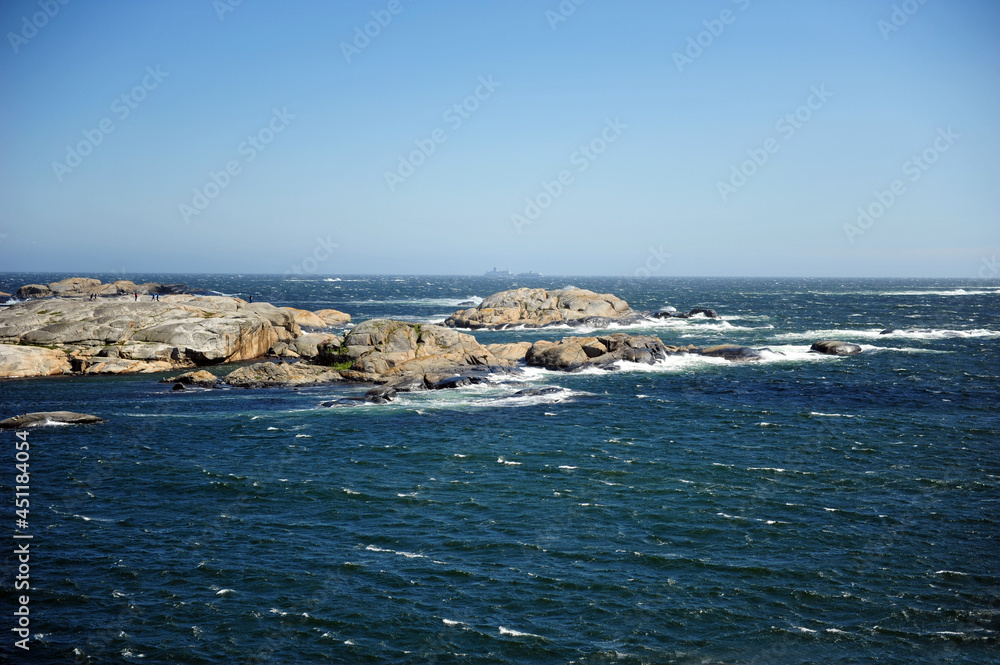 Beautiful seascape with tiny islands. Horizontal photo with copy space. Sunny and windy weather.