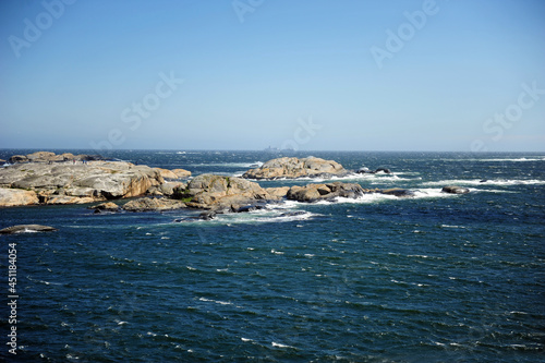 Beautiful seascape with tiny islands. Horizontal photo with copy space. Sunny and windy weather.