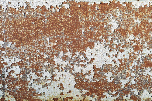 Painted in white old cracked metal rusted background. Metal rust texture. Erosion metal. Scratched and dirty texture on outdoor rusted metal wall.
