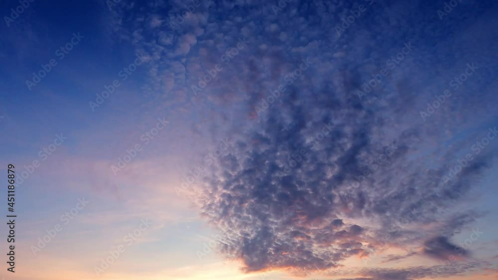 Sunrise or sunset on pastel blue sky with dark clouds Sunrise or sunset on pastel blue sky with dark clouds
