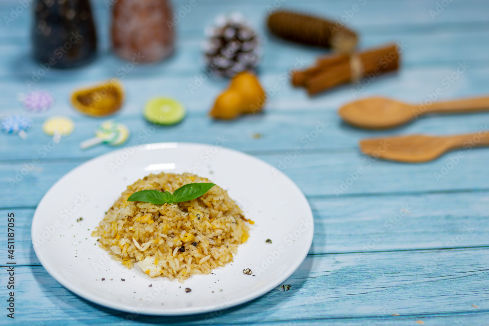 The brown soy sauce egg fried rice looks appetizing on the dining table. The brown soy sauce egg fried rice looks appetizing on the dining table.
