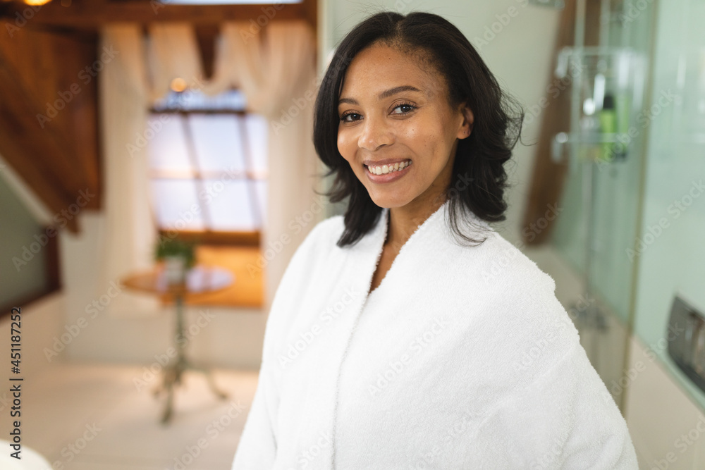 Portrait of smiling mixed race woman in bathroom looking at camera Portrait of smiling mixed race woman in bathroom looking at camera