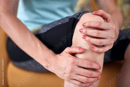 Woman with knee and joint pain at home.