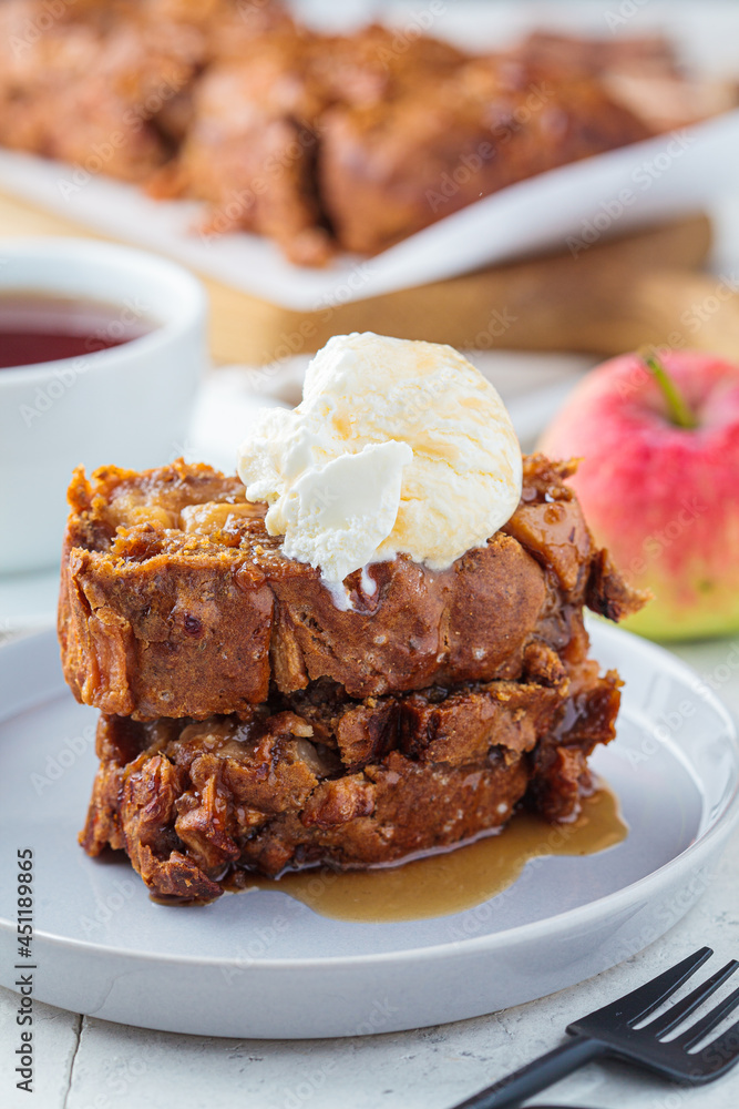 Apple bread with a scoop of ice cream and maple syrup on a gray plate. Autumn fruit pie, gray background. Apple bread with a scoop of ice cream and maple syrup on a gray plate. Autumn fruit pie, gray background.