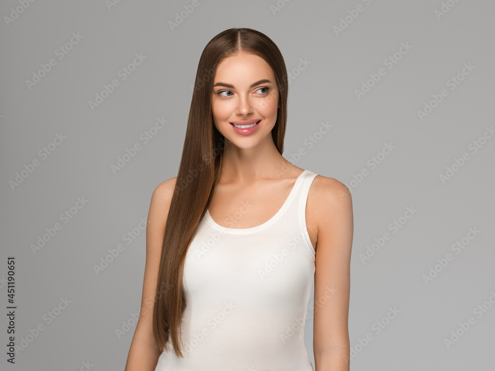 Beautiful woman with long smooth hair natural make up over gray background Beautiful woman with long smooth hair natural make up over gray background