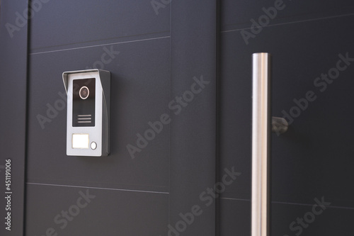 entrance door to a house with a doorbell with camera photo