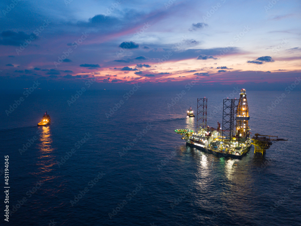 Offshore Jack Up Rig in The Middle of The Sea at Sunset Time for Petroluem Exploration and Production