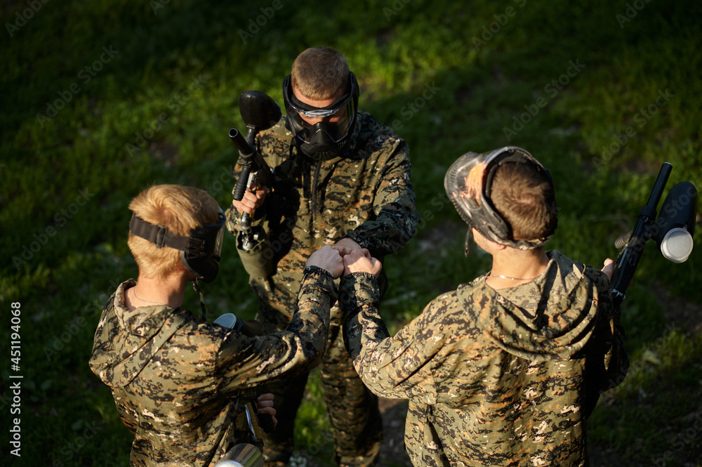Team playing paintball, battle in the forest Team playing paintball, battle in the forest