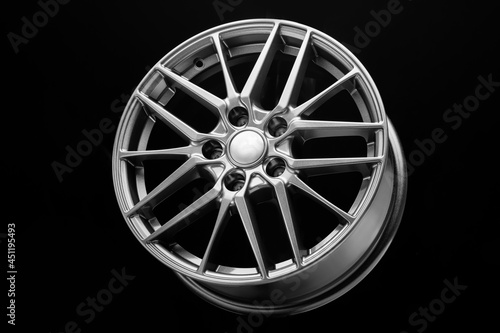 new sporty lightweight alloy wheel, spokes and rim on a black background