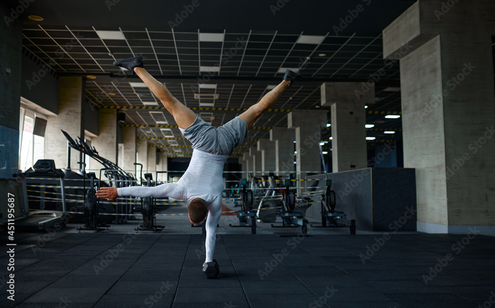 Strong man doing exercise, fitness training in gym