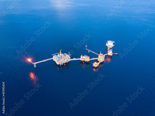 Central processing platform (cpp) in the middle of the ocean during sunset time - upstream industry. photo