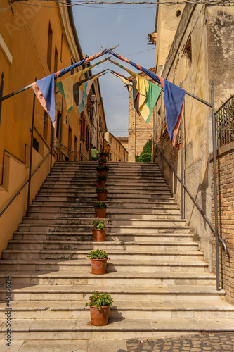 View on a staircase with medieval flags in Offagna, Marche - Italy