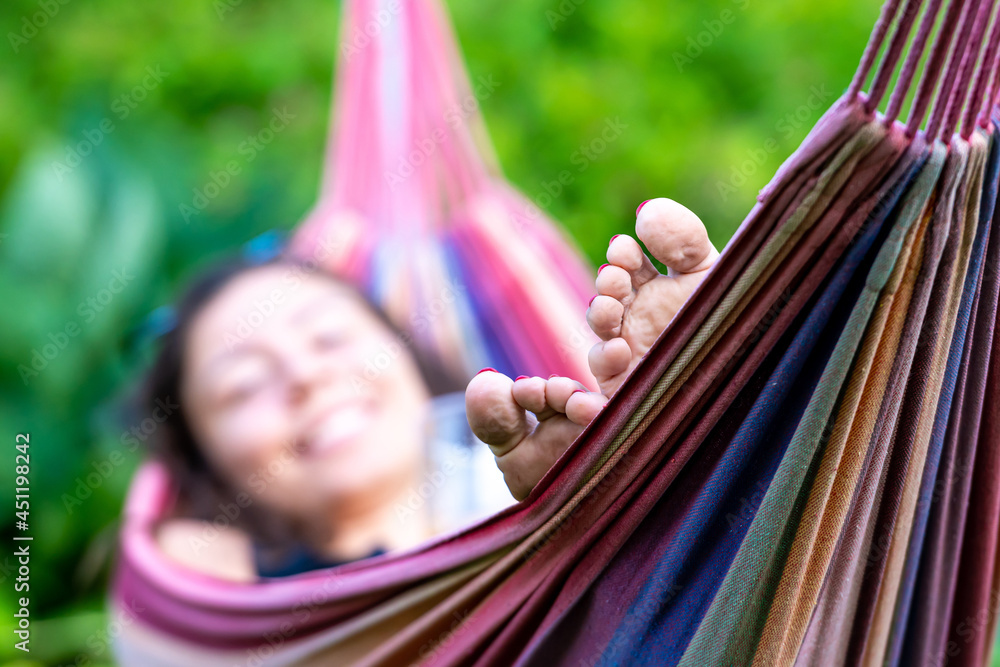 female is chilling and relaxing in the hammock, selective focus, focus on the feet female is chilling and relaxing in the hammock, selective focus, focus on the feet