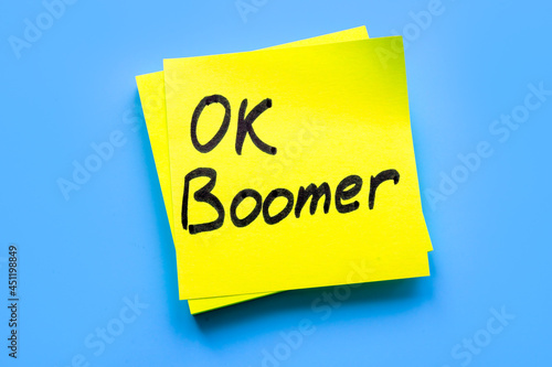 OK boomer words on the yellow piece of paper. photo