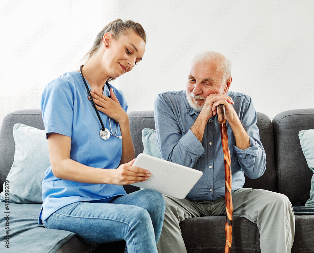 nurse doctor senior care tablet computer technology showing caregiver help assistence retirement home nursing elderly man