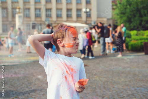 Happy boy throwing colorful powder. Concept for Indian festival Holi.